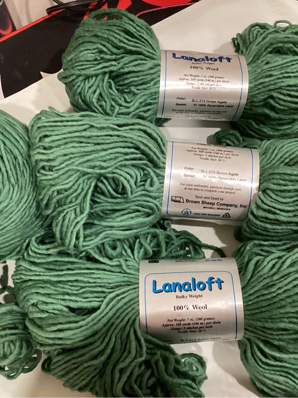 4 hanks + partial of brown sheep co’s Lanaloft bulky weight yarn in green agate